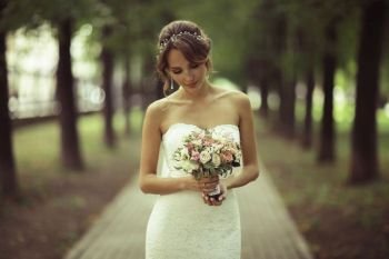 Bride with a bouquet of flowers in a white dress at a wedding