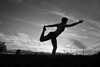 Silhouette of a young girl yoga pose sunset sport
