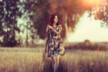 girl sunset in the rustic landscape of wheat