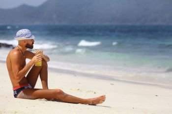 tanned, bearded man in sunglasses vacation concept