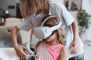 Two happy kids with pleasure playing video games. Advanced children study modern virtual reality technologies. Active childhood.. Brother and Sister Playing Video Game