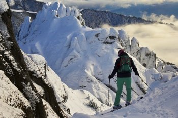 Skier man in safe ski equipment in Ciucas Mountains, Romania