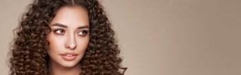 Fashion studio portrait of beautiful woman with afro curls hairstyle. Facial treatment. Cosmetology, beauty and spa
