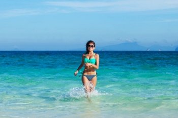 Beautiful fit woman in bikni run to tropical beach. Beautiful woman in bikni run