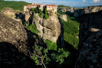 Monastery of Varlaam monastery and Monastery of Rousanou in famous greek tourist destination Meteora in Greece on sunset with scenic scenery landscape. Monasteries of Meteora in Greece