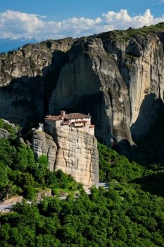 Monastery of Rousanou in famous greek tourist destination Meteora in Greece on sunset with scenic landscape.. Monastery of Rousanou in Meteora in Greece
