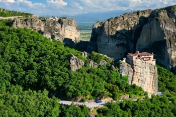Monastery of Rousanou and Monastery of St. Stephen in famous greek tourist destination Meteora in Greece on sunset with scenic landscape.. Monastery of Rousanou and Monastery of St. Stephen in Meteora in Greece