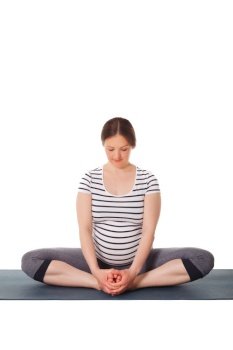 Pregnancy yoga exercise - pregnant woman doing asana Baddha Konasana Bound Angle Pose isolated on white background. Pregnant woman doing yoga asana Baddha Konasana