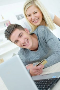 Couple shopping on-line with a credit card