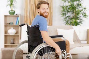 man in wheelchair at home