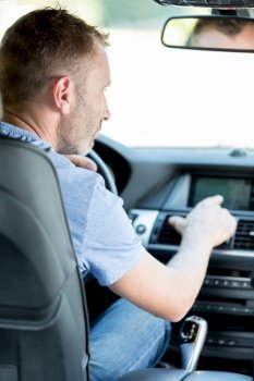 man using gps navigation system in car