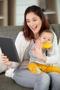 happy mom and cute kid baby using a tablet
