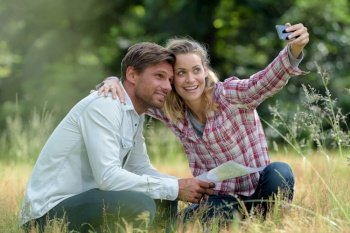 couple taking selfie on the grass