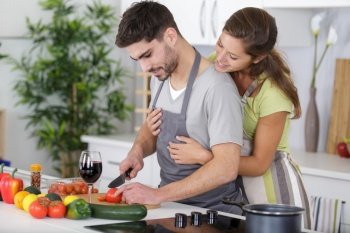 beautiful young couple hugging in kitchen