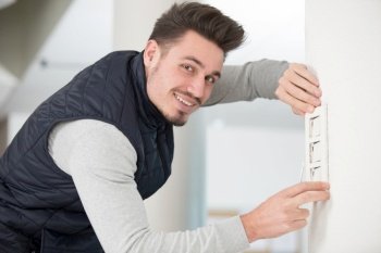 electrician man installing switch