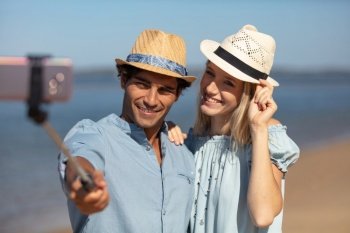 beautiful happy smiling funny couple makes selfie on smartphone