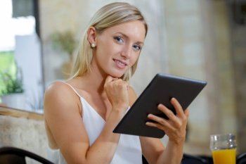 attractive young woman with tablet in cafe