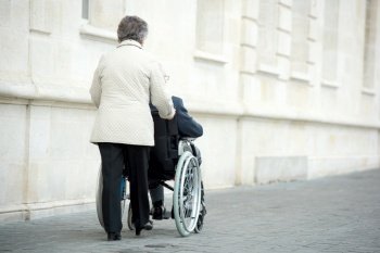 a senior couple in wheelchair
