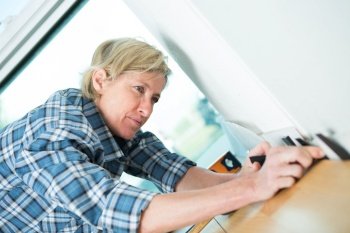 Woman pressing down laminate flooring