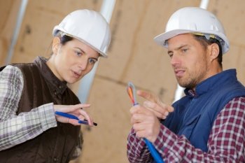 professional electrician workers with safety protective equipment to install internet