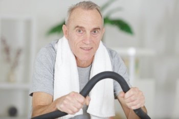 senior man exercising on step machine