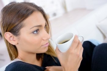 portrait of a young woman drinking coffee