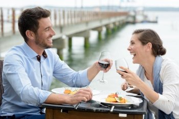 romantic couple in love having dinner at sea beach restaurant