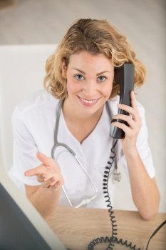 young female doctor answering phone calls