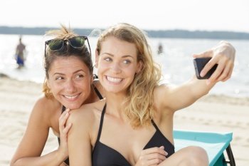 two women do selfie on vacation on the beach