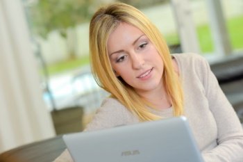 Blond woman using a laptop