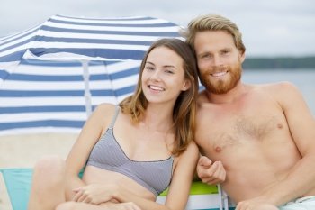 couple on the beach smiling