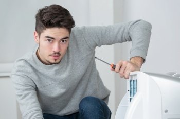 Portrait of young man with electrical appliance