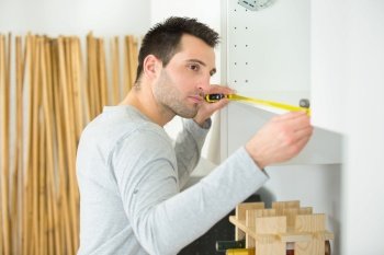 carpenter installing luxury fitted kitchen