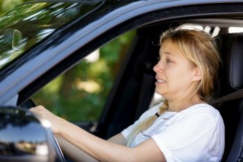 lady driver with fearful expression trying to slow down
