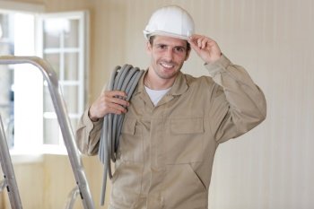 male builder tipping hardhat in greeting
