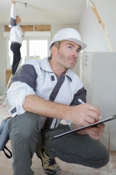senior builder supervisor with clipboard