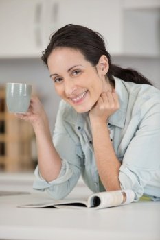 beautiful female holding cup with hot drink