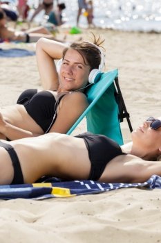 women sunbathing on the beach
