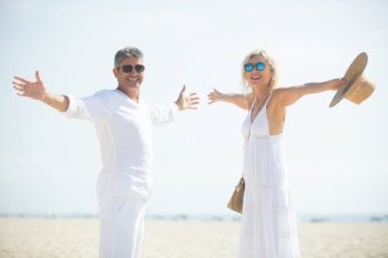 middle-aged couple embracing each other at the beach
