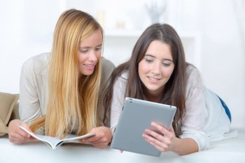 two young female friends using tablet pc