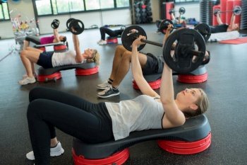 group of people doing power exercise workout in fitness club