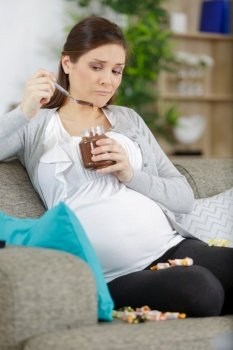 beautiful pregnant woman eating chocolate