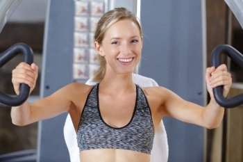 happy woman trains pectoral muscles