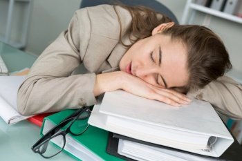 young woman sleeping at workplace