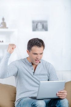 successful excited man with laptop