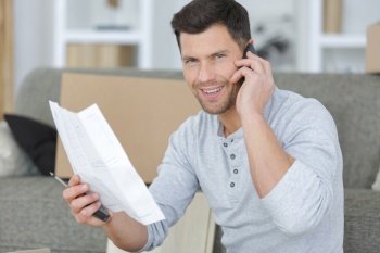 man on the phone while reading a letter