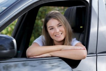 a happy female driver smiling at the camera