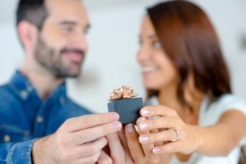 a couple is holding a present