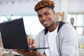 young man at home using a notebook computer