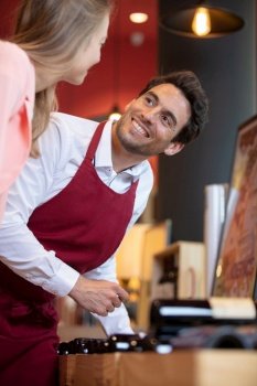 an attractive girl and a smiling barman flirting